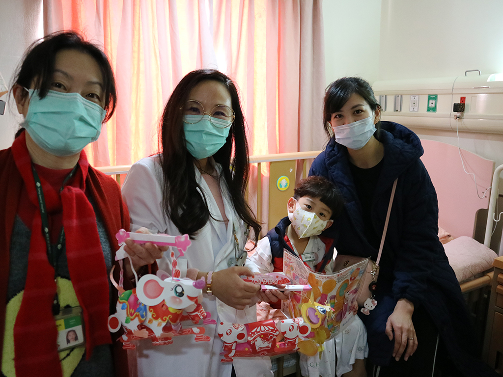 小兒科沈仲敏主任(左二)偕同公關人員至兒科病房發放生肖鼠燈籠予病童。